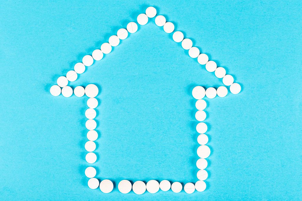 House of white pills on a blue background