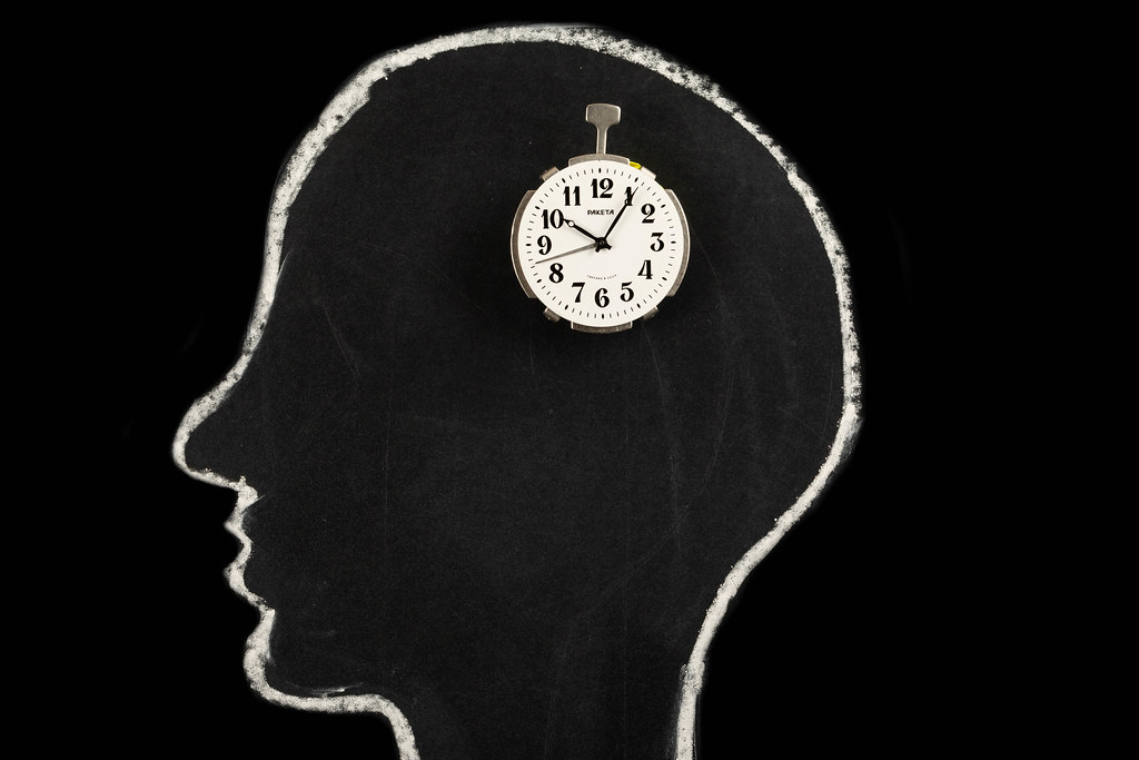 Human head silhouette with clock