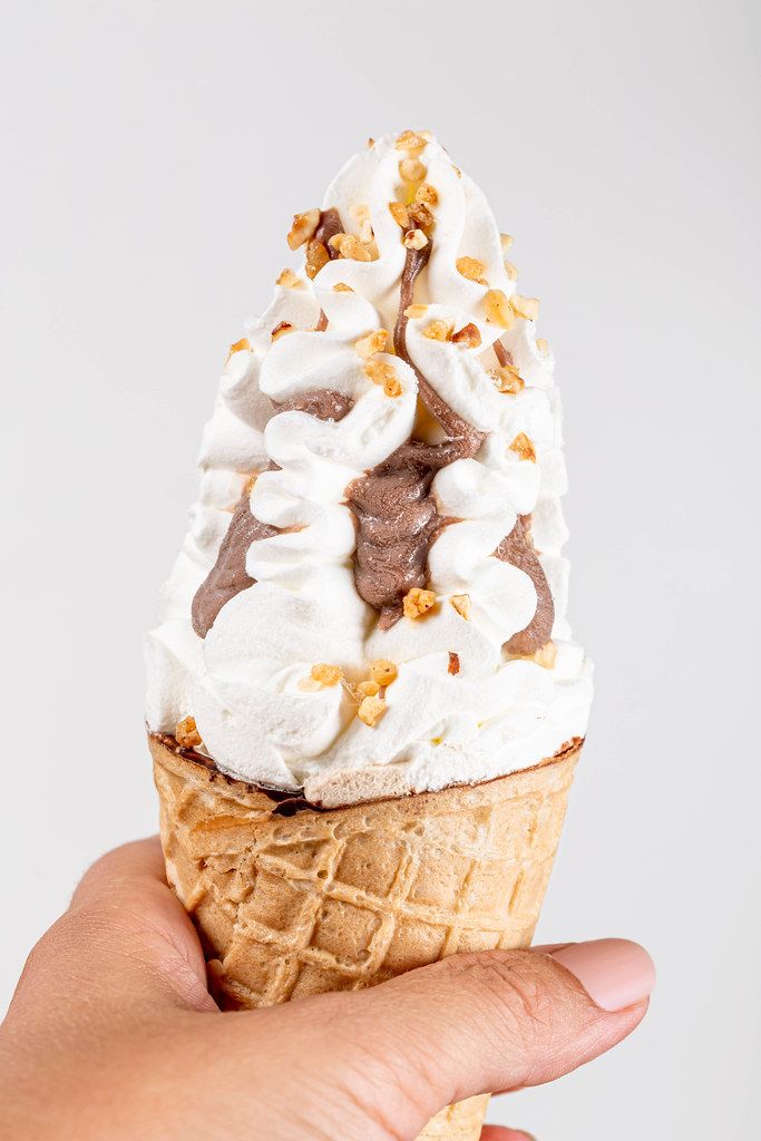 Ice cream cone in a woman's hand close up