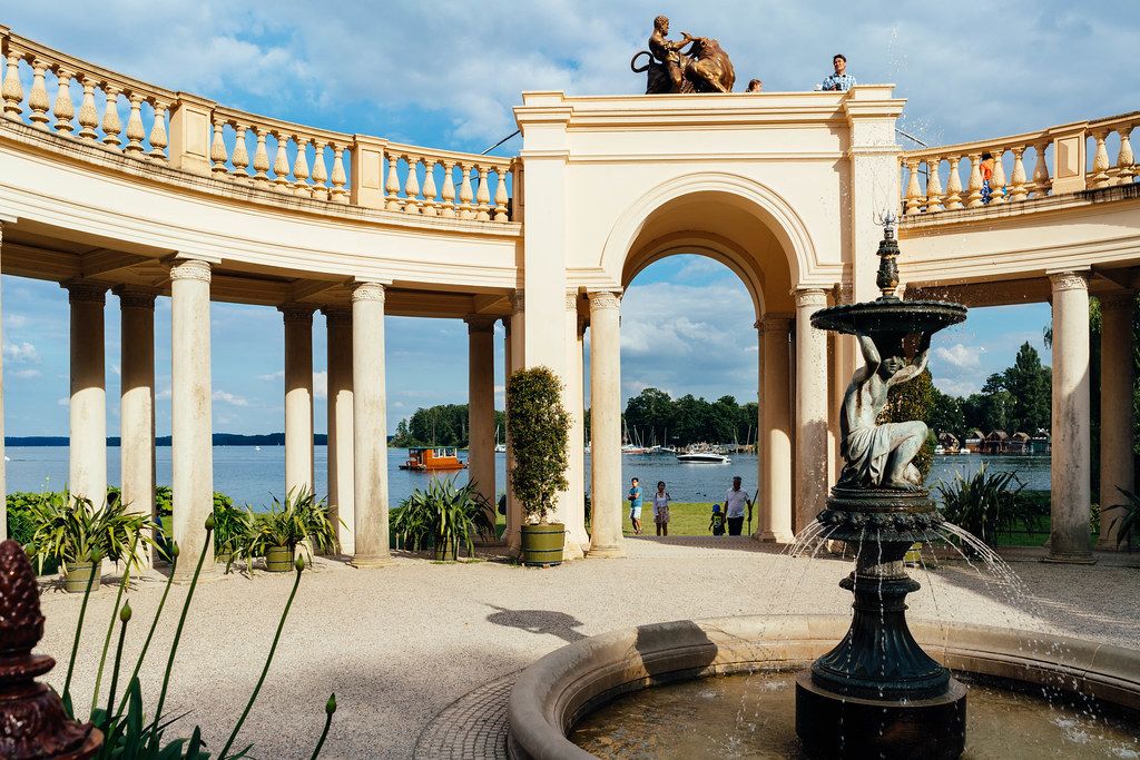 Inner yard of Schwerin castle with fountain, sculptures and arch and column passage