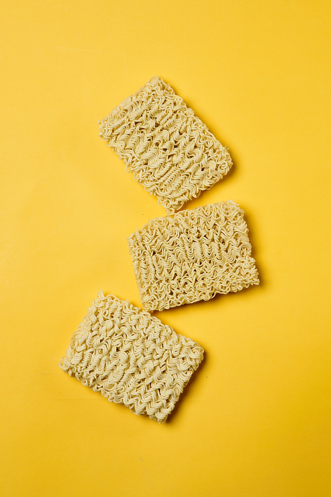 Instant noodles on yellow background
