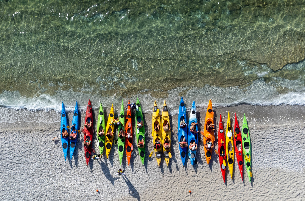 Kayaking on the Greek island of Skopelos: top view of many colourful kayaks lined up on Milia Beach