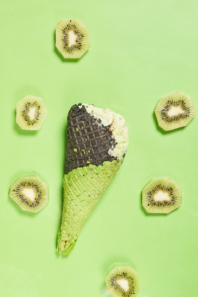 Kiwi ice cream on green background