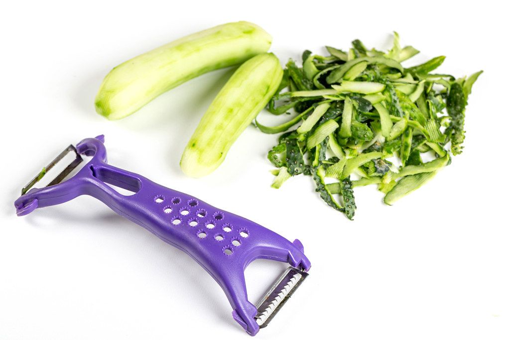 Knife for cleaning vegetables and fruits with cucumber and peeled skin