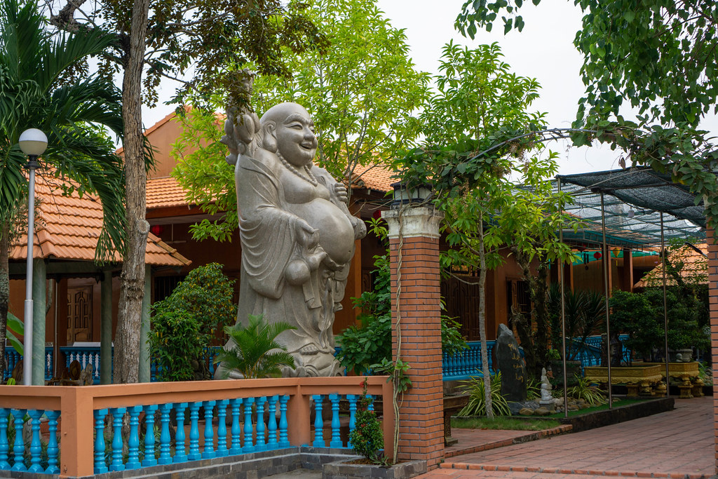 Large Future Buddha Statue called Maitreya in front of a Building at a Pagoda in Can Tho, Vietnam