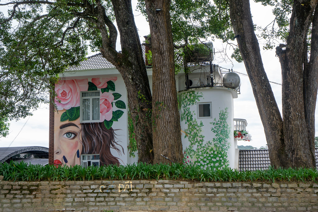 Large Wall Art of a Woman with Flowers and Plants on a White House in Dalat, Vietnam
