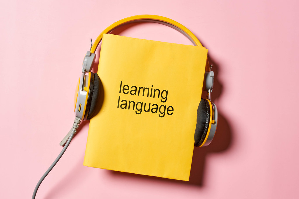 Learning a foreign language - headphones and book