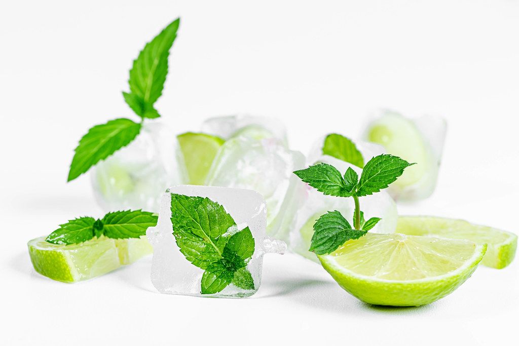 Lime and mint with ice cubes on a white background