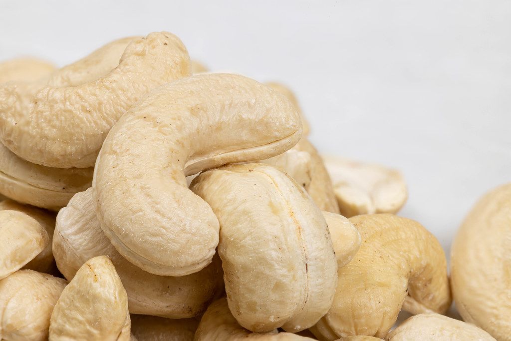 Macro of Cashew nuts pile with grey background