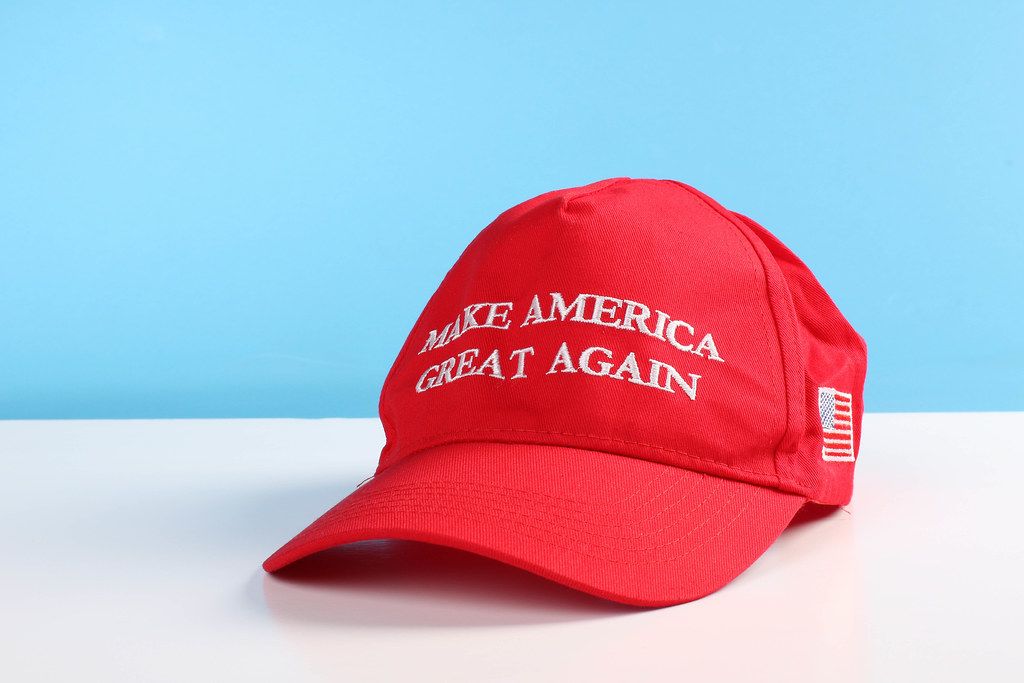 Make America Great Again Hat on white table with blue background