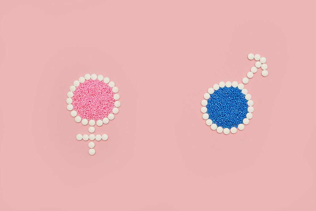 Male and female signs made of medical pills