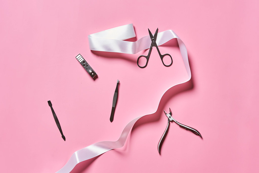 Manicure tools on pink background