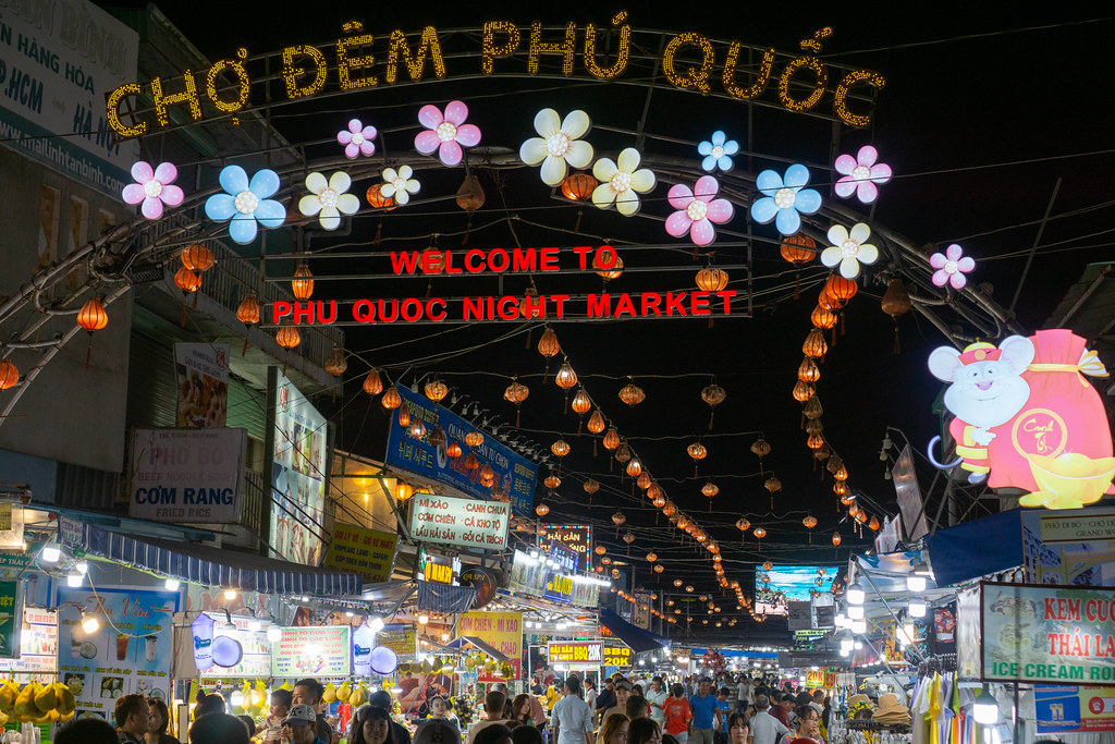 Many Street Food Carts, Shops, Restaurants and Massage Parlors at the Phu Quoc Night Market in Vietnam with Welcome Sign