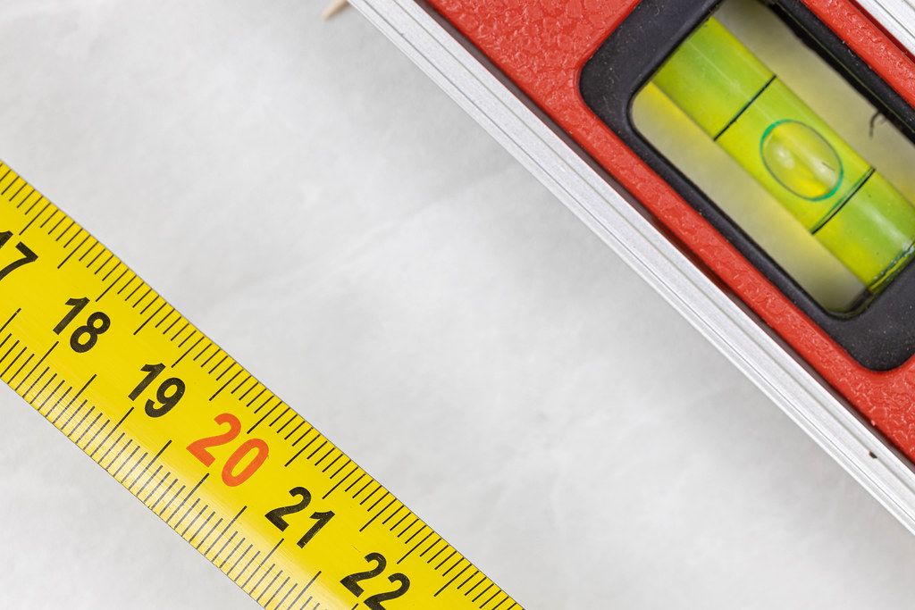 Measuring Tape with Level in Construction Concept