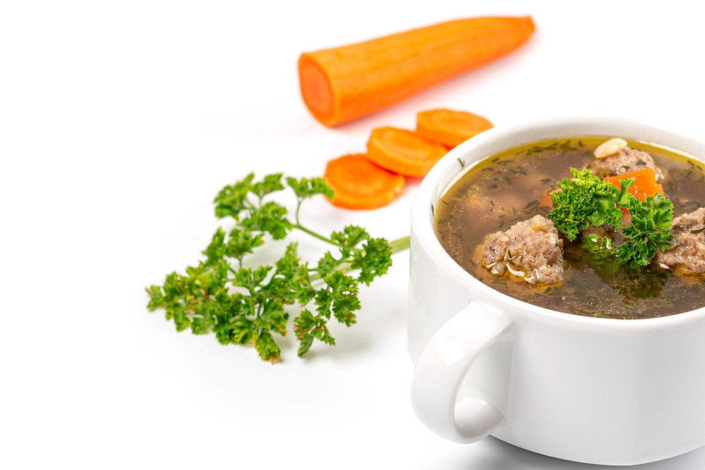 Meatball soup with vegetables and fresh parsley