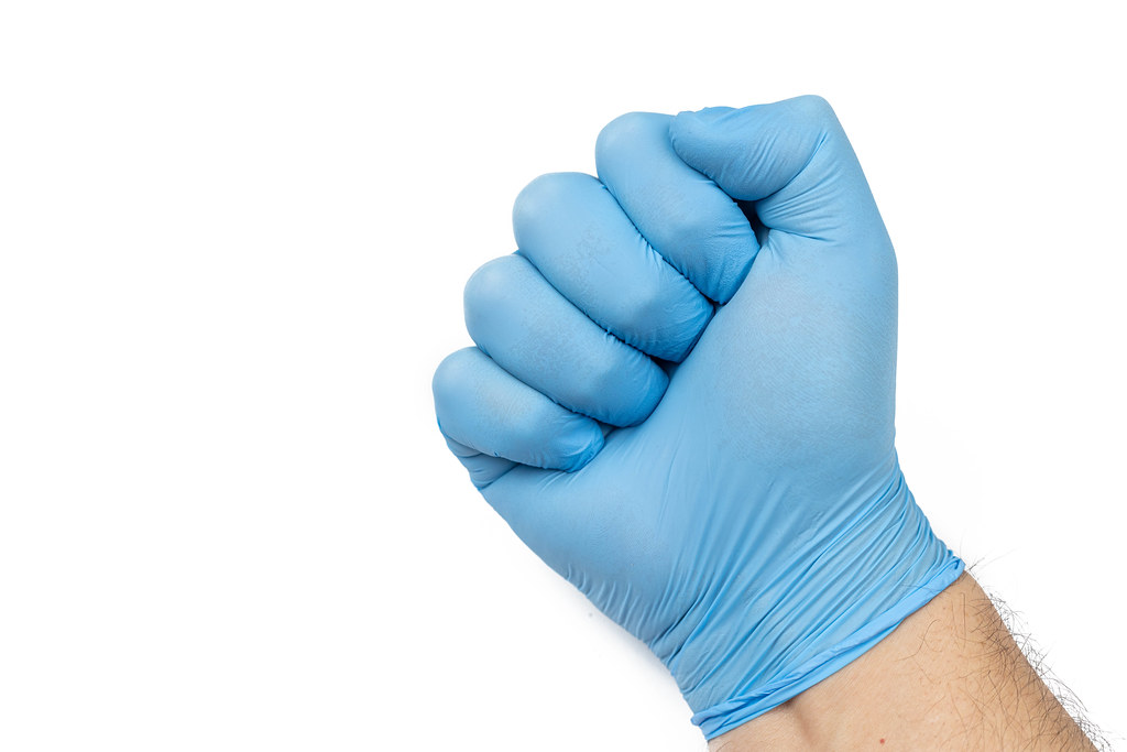 Medical Blue Glove on the hand with Fist and copy space
