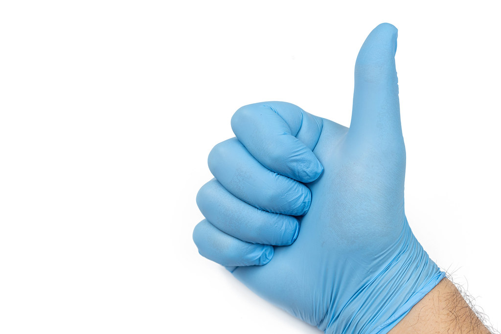 Medical Blue Glove on the hand with Thumb Up and copy space