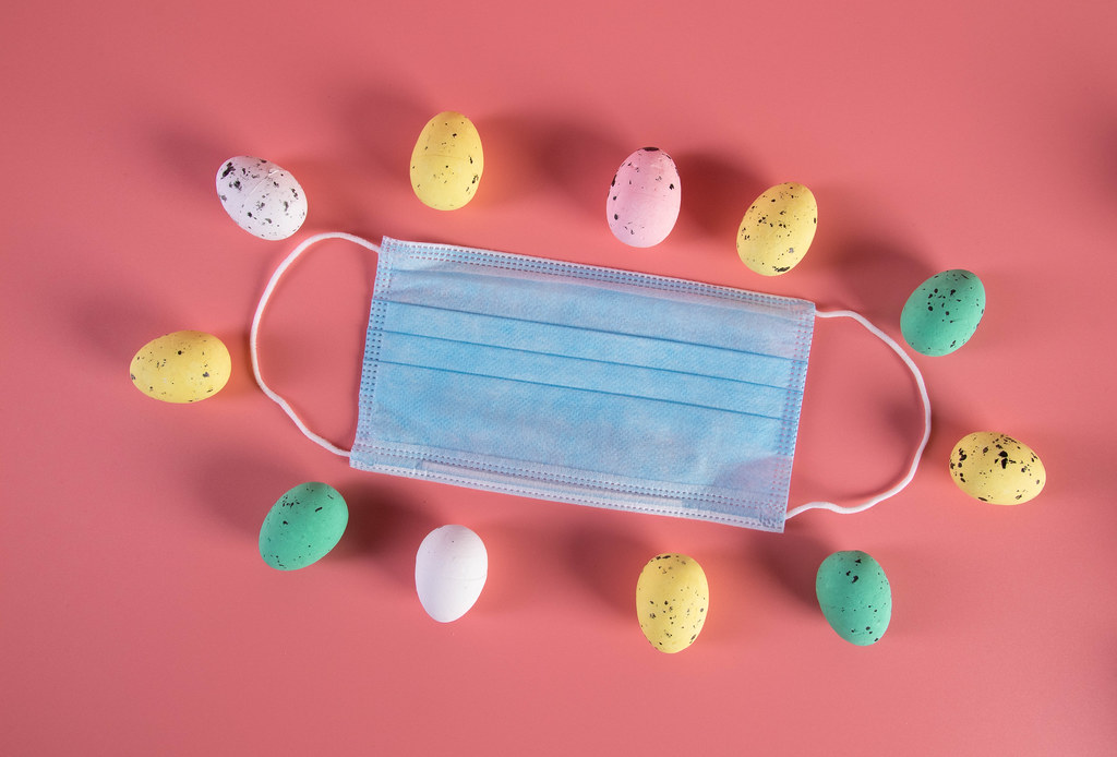Medical face mask and colorful easter eggs