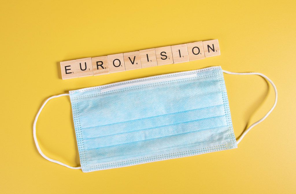 Medical face mask and Eurovision text on yellow background