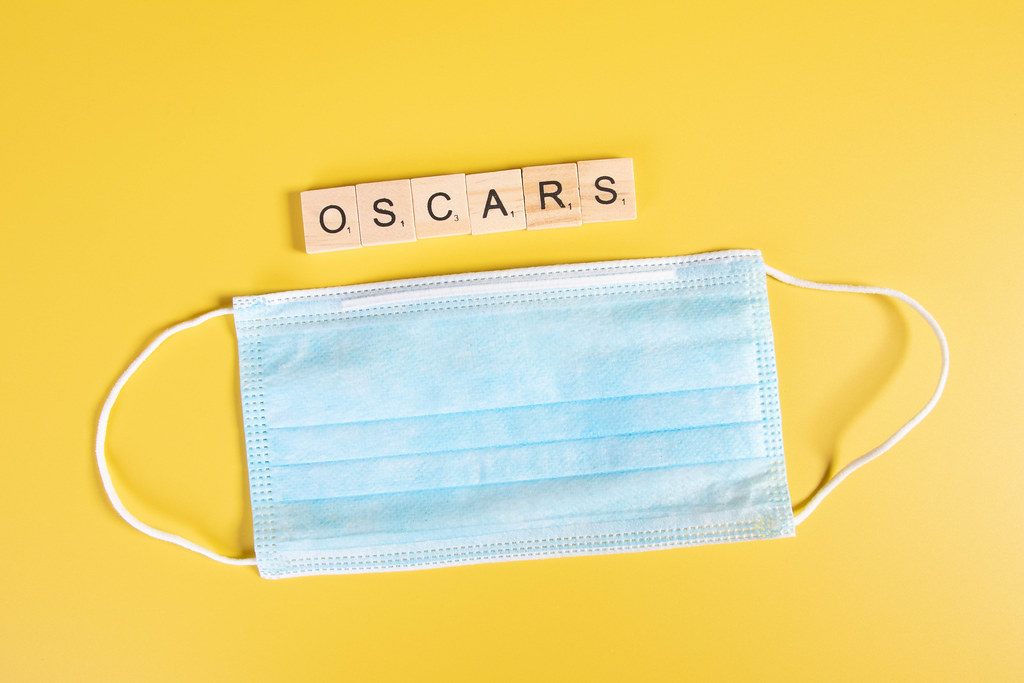 Medical face mask and Oscars text on yellow background