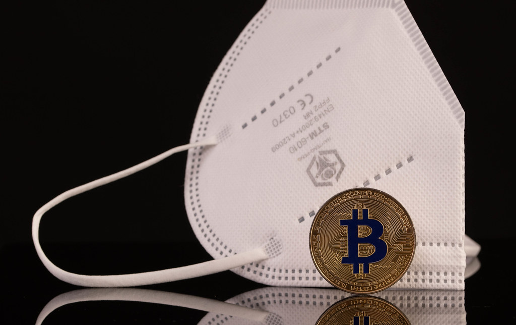 Medical face mask with golden Bitcoin on black background
