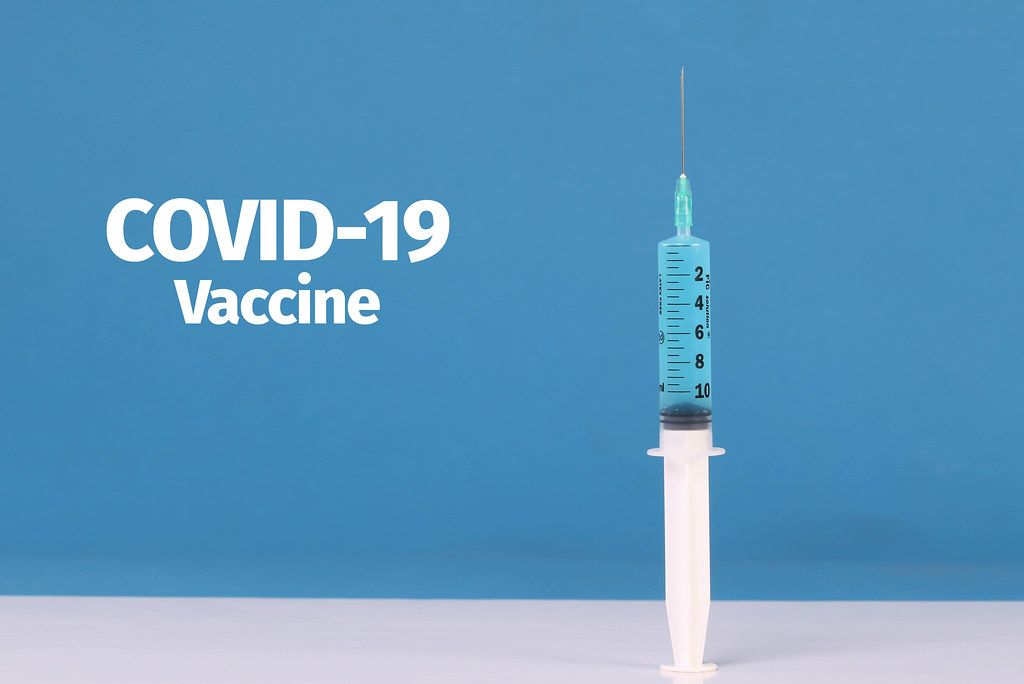 Medical syringe with COVID-19 Vaccine text