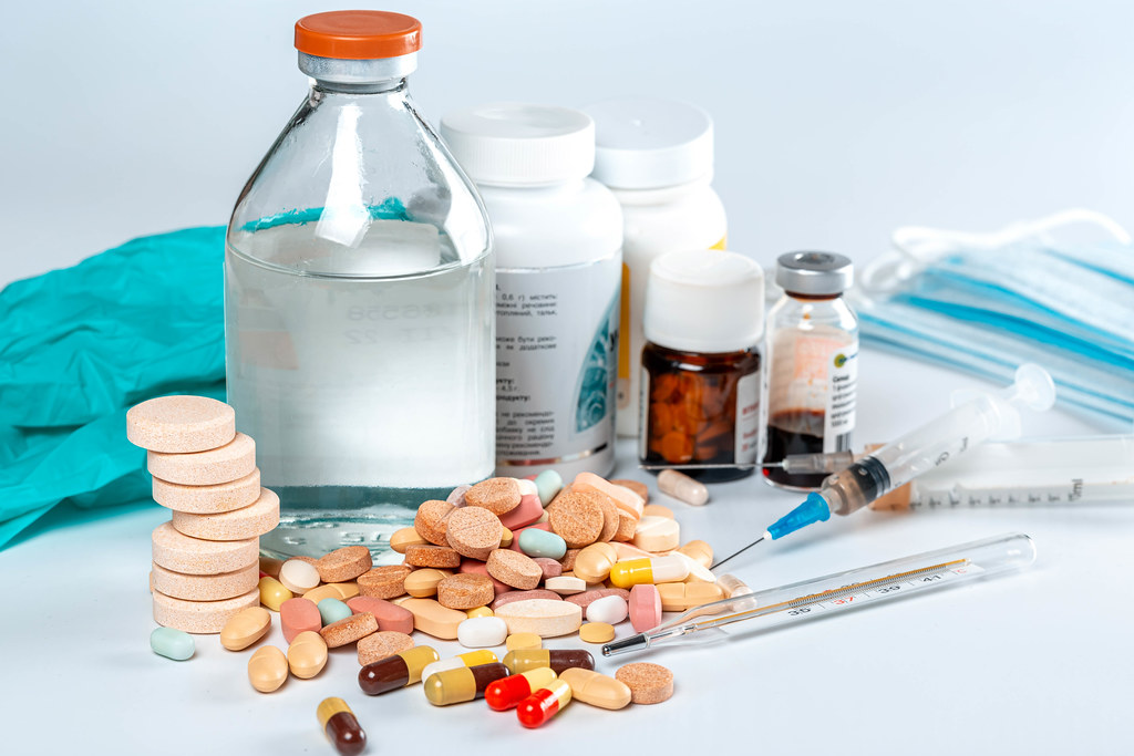 Medicines background with multicolored pills and medicine bottles