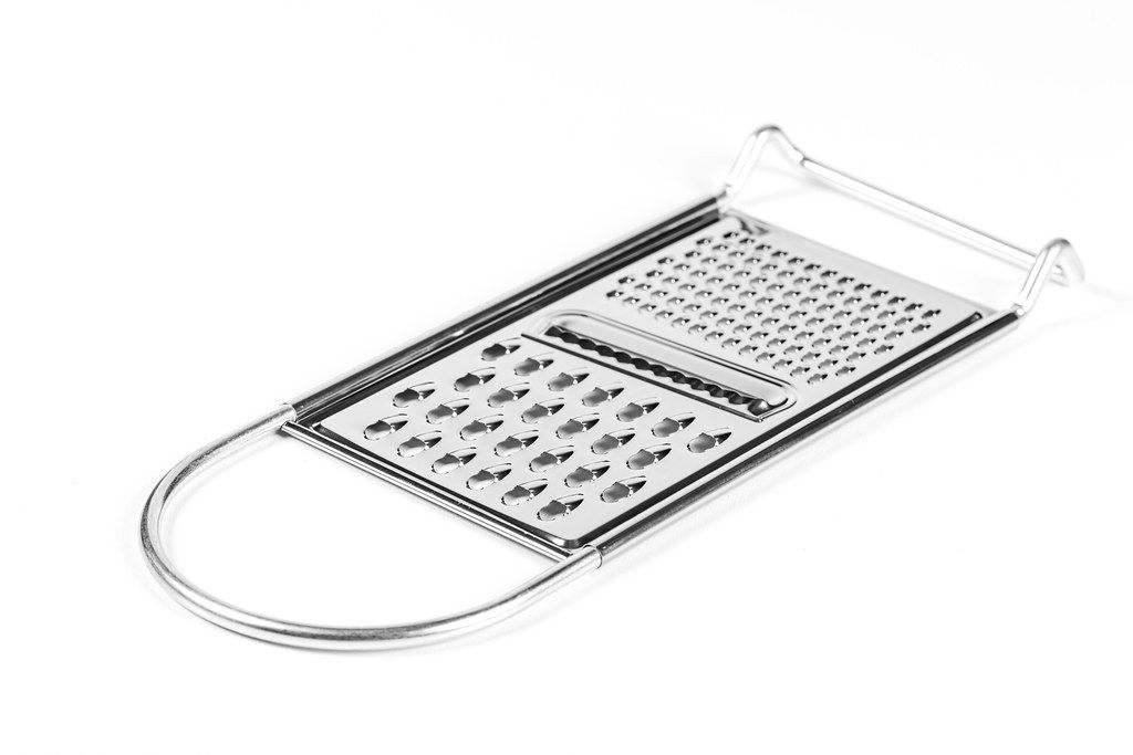 Metal new grater on white background