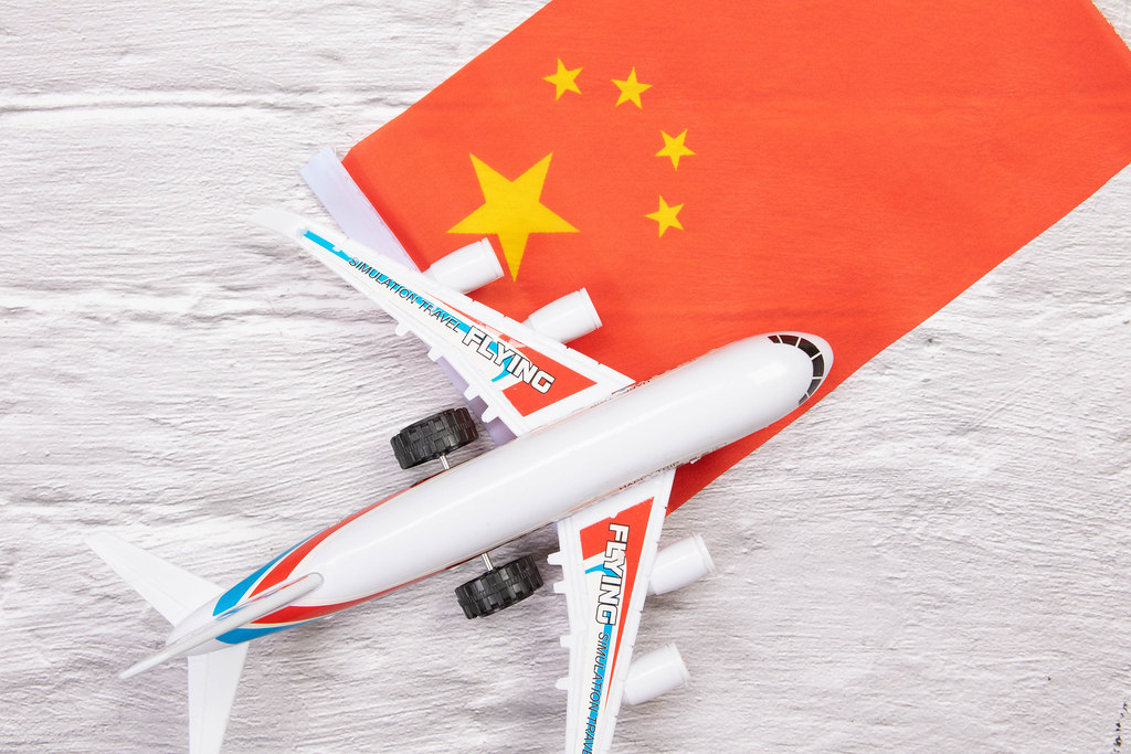 Miniature airplane over flag of China