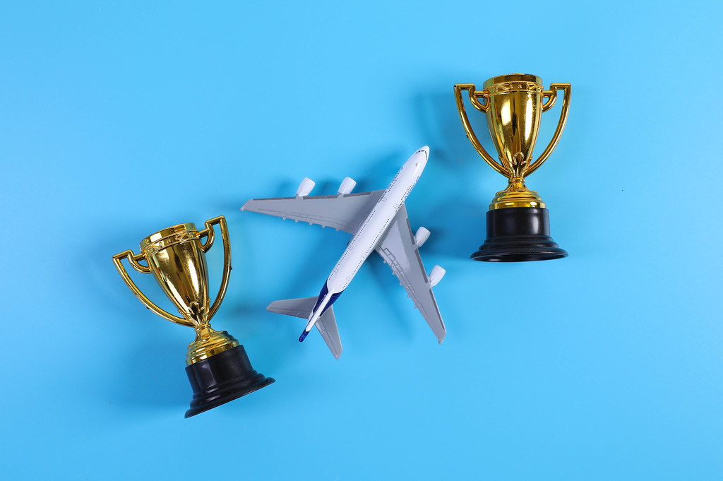 Miniature airplane with golden trophies