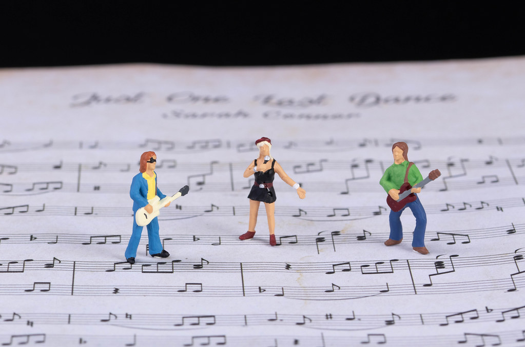 Miniature band standing on music notes