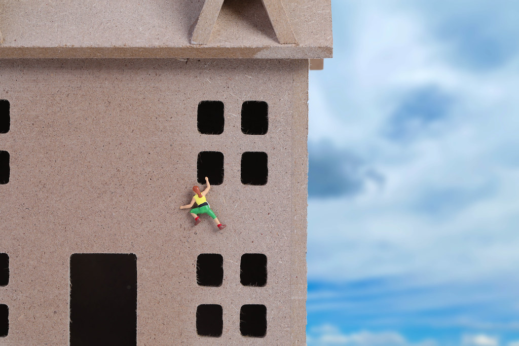 Miniature climber climbing on house