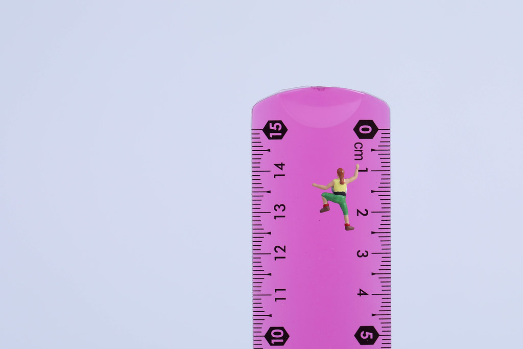 Miniature climber on school measuring ruler