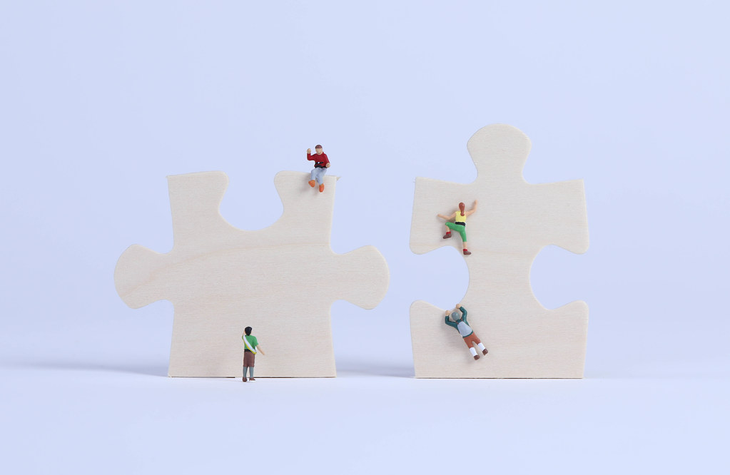 Miniature climbers on puzzle pieces