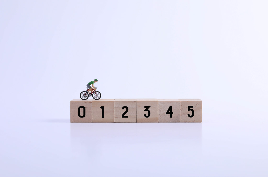 Miniature cyclist on wooden blocks with numbers