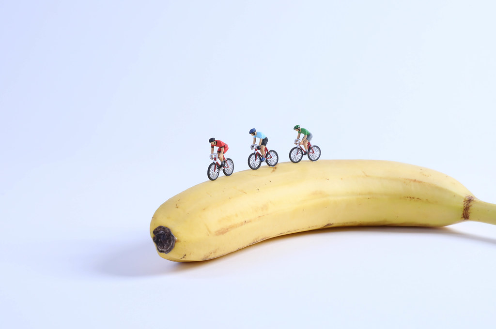Miniature cyclists on banana