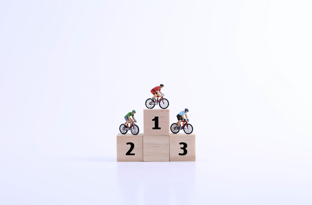Miniature cyclists on podium