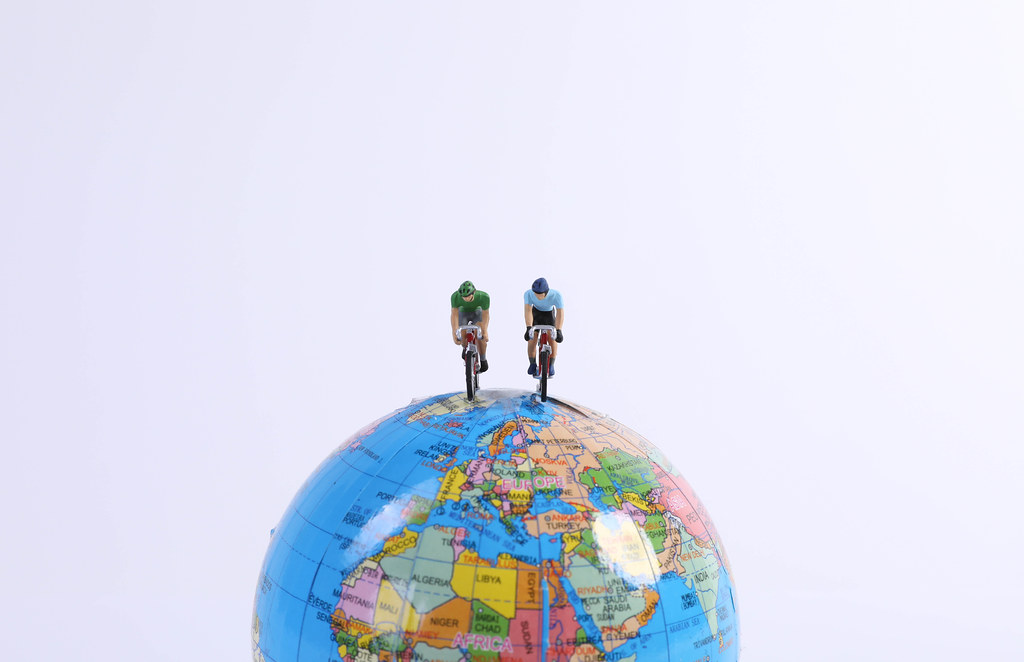 Miniature Figures Ride Bicycle on globe