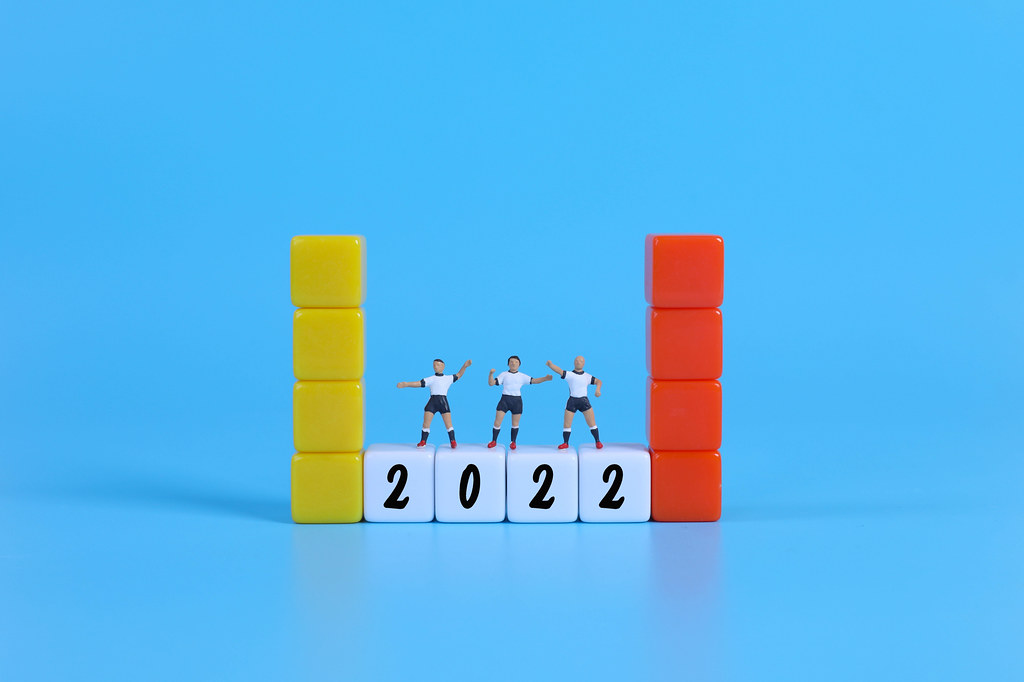 Miniature football players on blocks with 2022 text