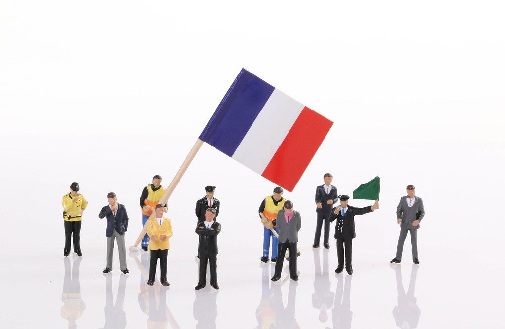 Miniature people with flag of France