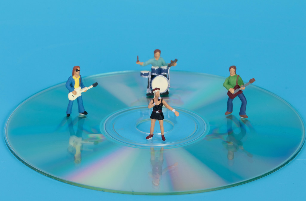 Miniature rock band standing on CD