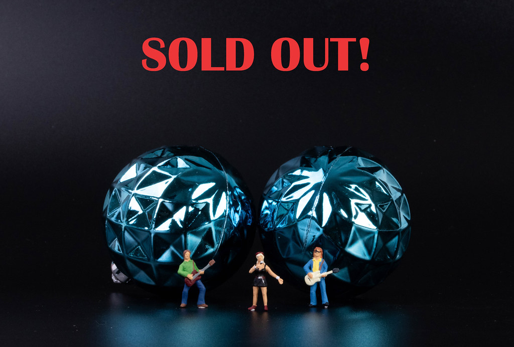 Miniature rock band with Sold out text