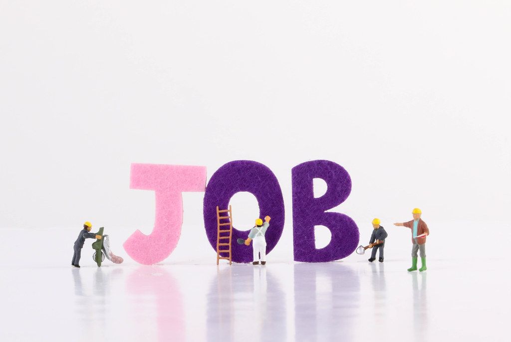 Miniature workers with Job text on white background
