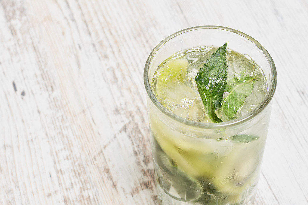 Mojito cocktail or non-alcohol drink with mint and sliced kiwi fruits