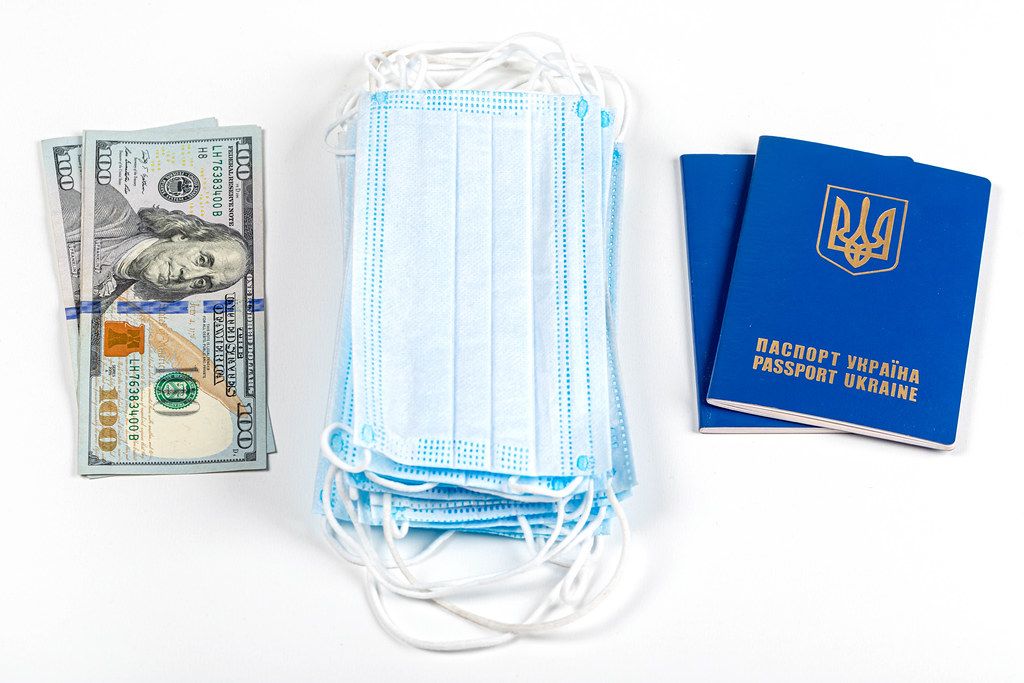 Money, medical masks and passports on a white background