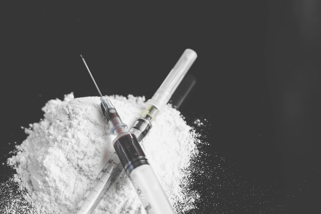 Morphine powder and syringes. Narcotics addiction