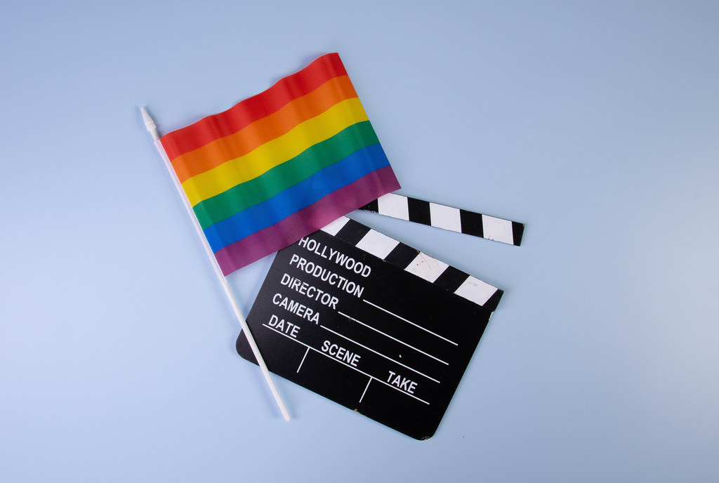 Movie clapper and rainbow flag