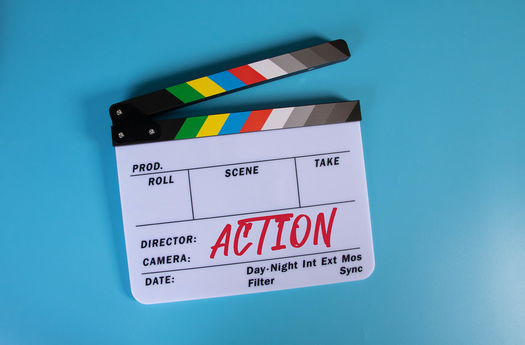 Movie clapper with Action text on blue background