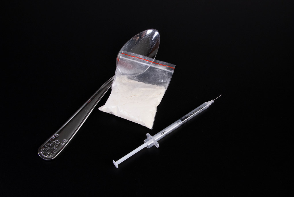 Narcotics With Syringe And Spoon On Table