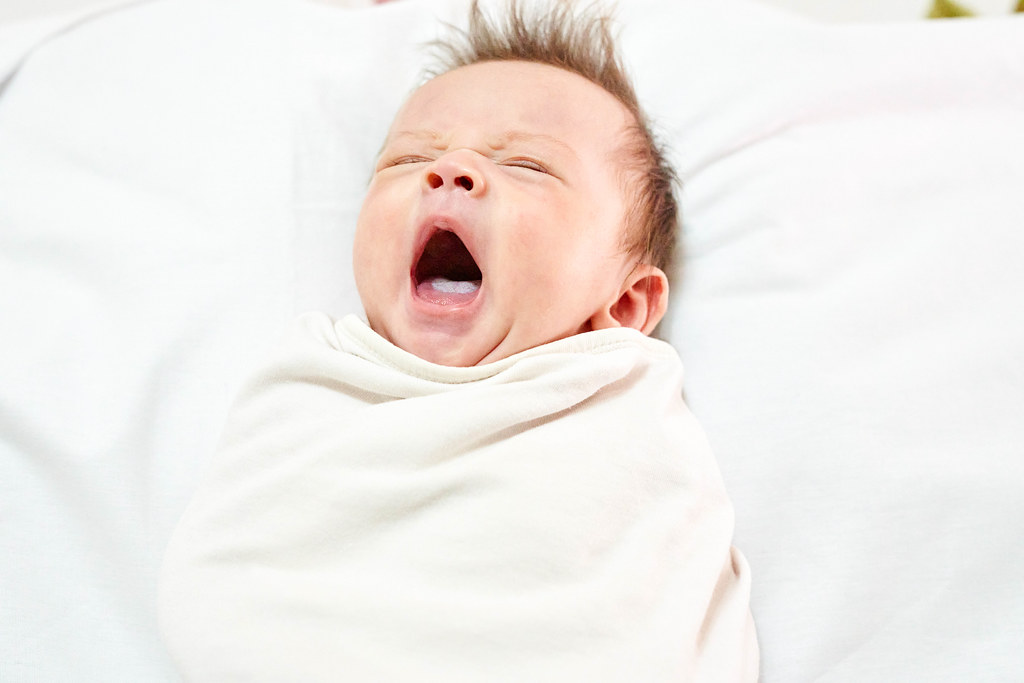 Newborn baby boy yawning